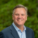 A professional headshot of a man.