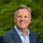 A professional headshot of a man.