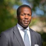 A professional headshot of a man.